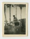 Arthur Howe, Jr. on his lorry in a shady spot near Alexandria, Egypt. Recto