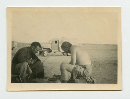 Arthur Howe, Jr. playing chess with Charles "Chuck" Carroll near Tobruk, Libya. Recto