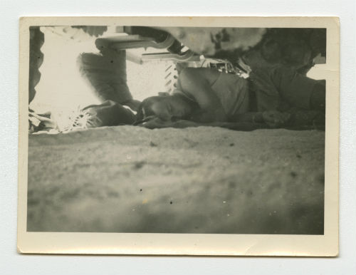 Arthur Howe, Jr. sleeping under an ambulance near Tobruk, Libya. Recto