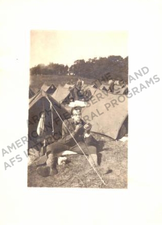 Robert Newman Slawson shaving in front of a tent.