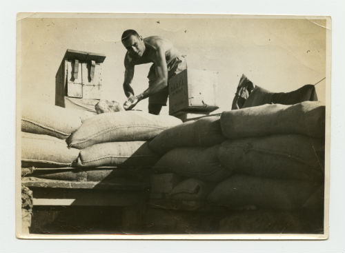 Arthur Howe, Jr. taking a morning bath on the top of his dugout in Tobruk, Libya. Recto